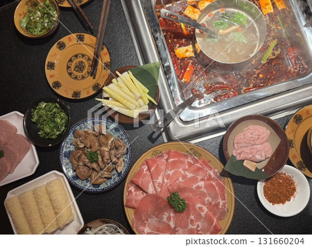 Spicy mandarin duck hot pot table with delicious ingredients 131660204