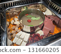 Hot pot ingredients: tofu, duck blood mushrooms, and quail eggs in a double-boiled pot 131660205