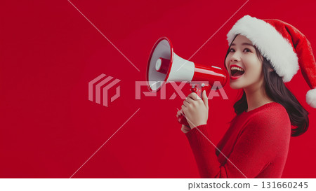 Japanese woman in Santa Claus costume holding megaphone, copy space Japanese woman in Santa Claus costume holding megaphone, copy space 131660245