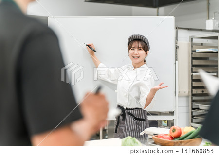 A female instructor (food coordinator/registered dietitian) who teaches at cooking seminars and study groups A female instructor (food coordinator/registered dietitian) who teaches at cooking seminars and study groups 131660853