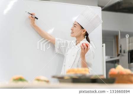 A female instructor who teaches at cooking seminars, vocational schools, and employee training A female instructor who teaches at cooking seminars, vocational schools, and employee training 131660894