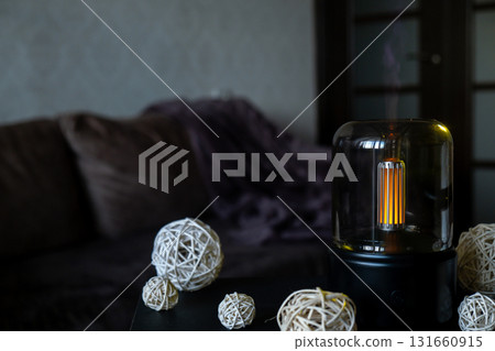 Indoors Decoration with modern lighted Air Humidification Aroma essential oil perfume fragrance. Scented home wellness wellbeing habit. Concept of feeling good spiritual health 131660915