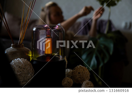 Close up of home perfume scent air humidifier with light. Aromatherapy holistic health practices concept. Stress relief activities preparing for meditation. Simple pleasures healing 131660916