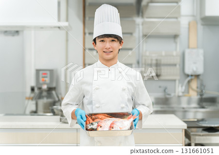 Male staff in chef's coats preparing fish (chef, fresh market, food processing) 131661051