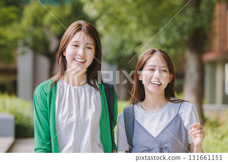 College student walking on campus with friends 131661151