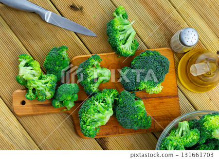 Sliced fresh broccoli on kitchen board. Cooking concept Sliced fresh broccoli on kitchen board. Cooking concept 131661703