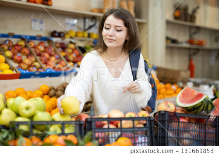 Woman choosing apples in the supermarket Woman choosing apples in the supermarket 131661853