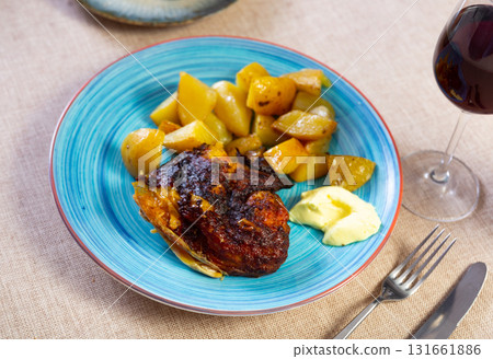 Baked chicken piece and potato in the plate Baked chicken piece and potato in the plate 131661886