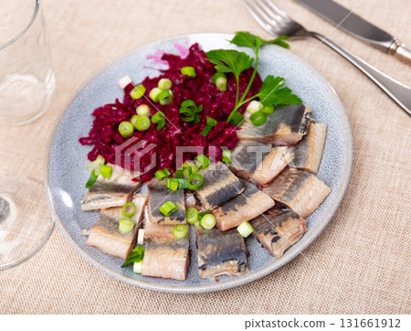 Lightly salted herring with beets served on platter 131661912