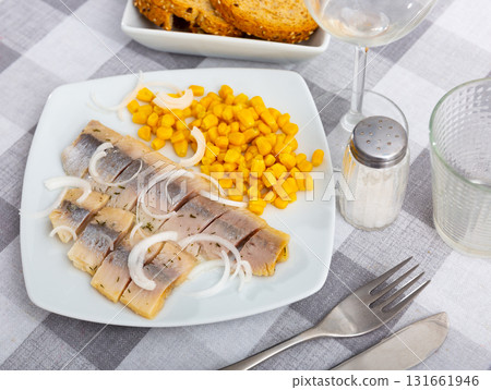 Slightly salted herring slices with pickled corn and fresh onion Slightly salted herring slices with pickled corn and fresh onion 131661946