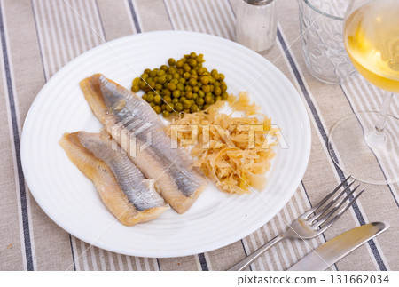 Filets of lightly salted herring with marinated cabbage and pickled peas Filets of lightly salted herring with marinated cabbage and pickled peas 131662034