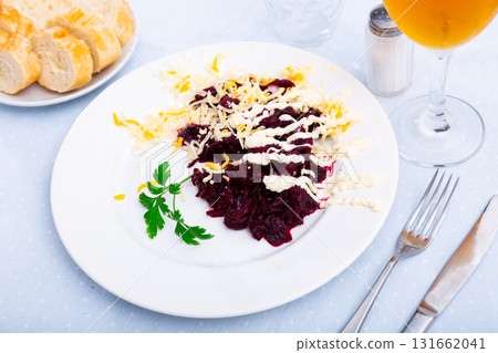 Salad of shredded beets with grated cheese, mayonnaise and greens 131662041
