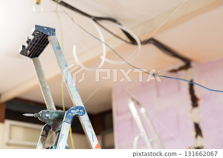 Stepladder in middle of a room under renovation in house 131662067