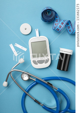 Blood glucose meter and medical tools on blue surface Blood glucose meter and medical tools on blue surface 131662173