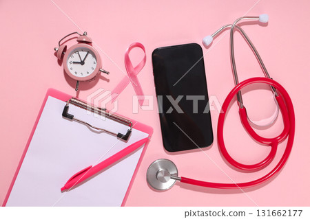 Medical items: clipboard, stethoscope, pink ribbon, top view 131662177