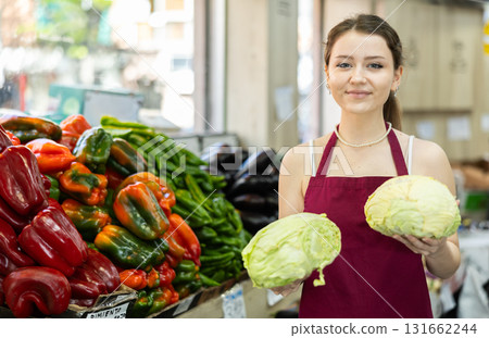woman seller offers white cabbage 131662244