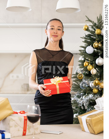 girl stands in apartment decorated for Christmas 131662276