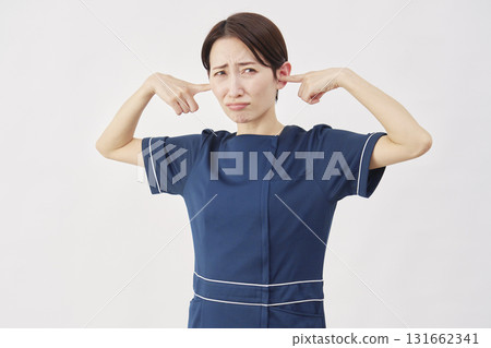 Female beauty nurse covering her ears white background 131662341