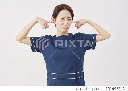 Female beauty nurse covering her ears white background Female beauty nurse covering her ears white background 131662342