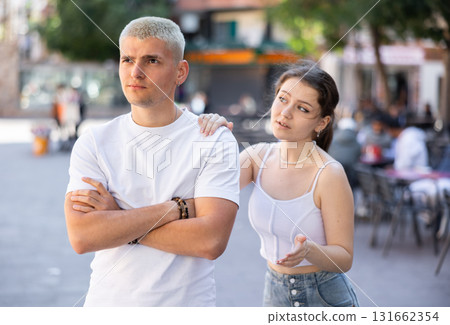 guy is offended by his girlfriend and is standing on the street 131662354