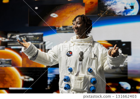 Joyous astronaut analyzing Mars planetary data in spacecraft powered by advanced engineering. Happy starship crew member exploring deep space, doing Martian surface research 131662403