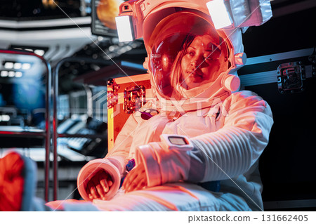 Dejected female astronaut showing signs of depression after extended time alone in space station. Worried woman in spaceship struggles with isolation as emotional strain grows in confined environment 131662405