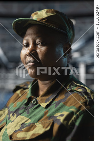 Close up of server hub employee in soldier uniform evaluating infrastructure resilience under enemy attacks. Army information technology specialist in data center testing classified defense software 131662497