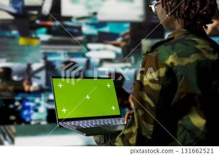 Close up of air defense expert using radar systems on isolated screen laptop to detect incoming ballistic missiles. Military soldier scanning rockets approaching borders using mockup notebook Close up of air defense expert using radar systems on isolated screen laptop to detect incoming ballistic missiles. Military soldier scanning rockets approaching borders using mockup notebook 131662521