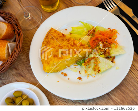 tortilla triangular pieces with green salad 131662526
