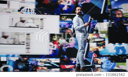 High tech lifestyle of a young guy scrolling through real time notifications, enjoying stream interaction and creative content in a modern virtual social network environment. Camera B. 131662562