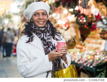 Positive Latin American woman stands with a paper cup 131662588