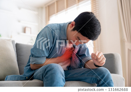 Young asian man with chest pain suffering from heart attack Young asian man with chest pain suffering from heart attack 131662688