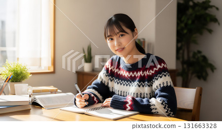 Lifestyle portrait of a young woman concentrating on her studies 131663328