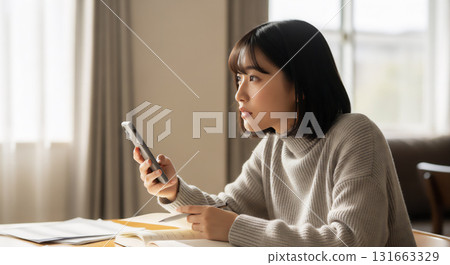 Lifestyle portrait of a young woman concentrating on her studies 131663329
