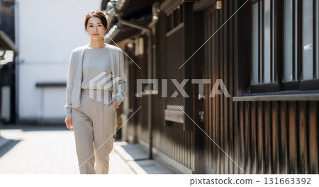 A natural portrait of a woman relaxing in the sunlight filtering through the trees A natural portrait of a woman relaxing in the sunlight filtering through the trees 131663392