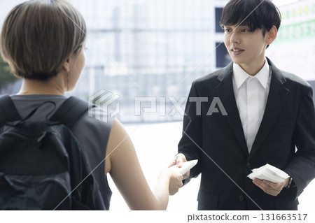 一名西裝革履的男子遞上紙巾 131663517