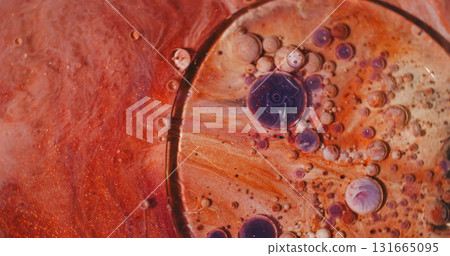 Oil fluid. Color bubbles. Defocused orange purple glitter water sparkling round ink texture circle on abstract acrylic background. Oil fluid. Color bubbles. Defocused orange purple glitter water sparkling round ink texture circle on abstract acrylic background. 131665095