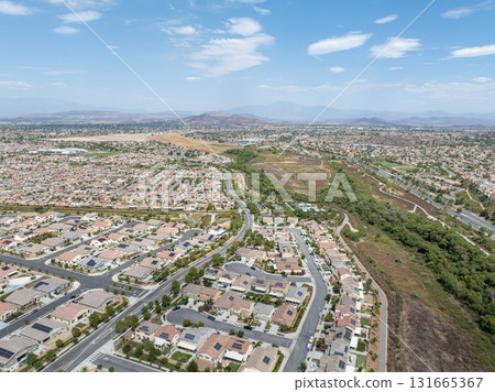 Aerial view of a sprawling neighborhood of family homes in Menifee, California, USA. Aerial view of a sprawling neighborhood of family homes in Menifee, California, USA. 131665367