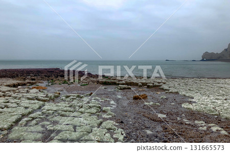 A serene coastal landscape with a rugged shoreline and calm waters, ideal for relaxation A serene coastal landscape with a rugged shoreline and calm waters, ideal for relaxation 131665573