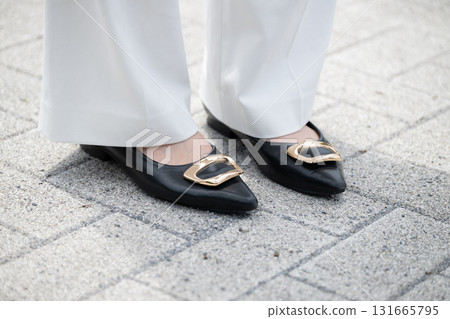 The feet of a woman wearing a suit 131665795