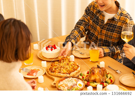 Family having a Christmas home party 131666692