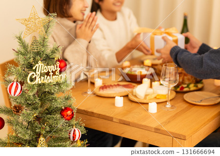 Family having a Christmas home party 131666694