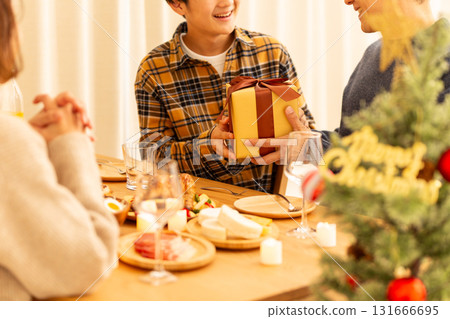 Family having a Christmas home party 131666695