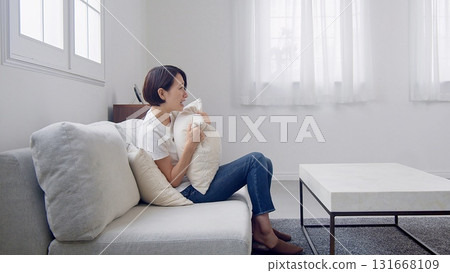 A woman watching TV A woman watching TV 131668109