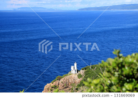 A lighthouse standing on a precipice 131669069
