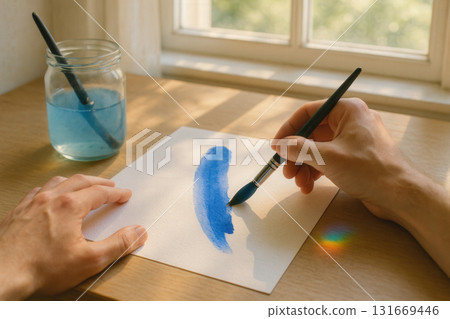 Creative Watercolor Brushstroke on Paper in Warm Morning Light 131669446