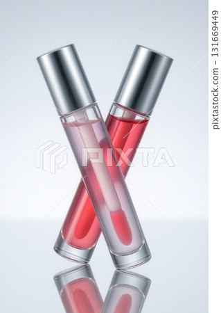 Elegant Lip Gloss Tubes Crossed in Minimal Cosmetic Composition 131669449