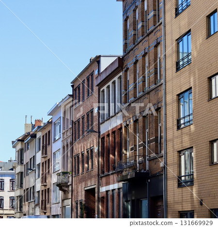 Old townhouses lining a city street with traditional brick facades and architecture. Antwerp, Belgium Old townhouses lining a city street with traditional brick facades and architecture. Antwerp, Belgium 131669929