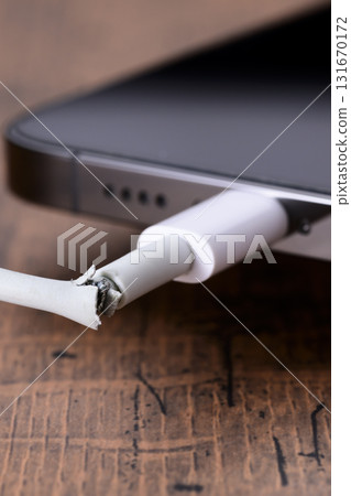 Broken smartphone charging cable 131670172