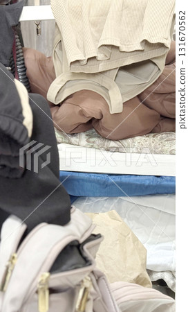 凌亂的女性衣服和包包_垂直寬 131670562